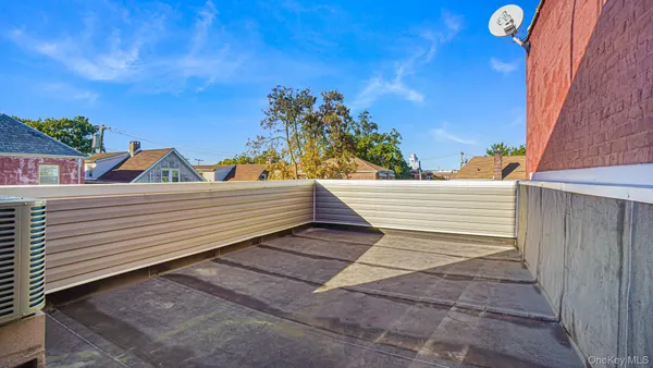 a view of a roof deck with wooden floor and fence