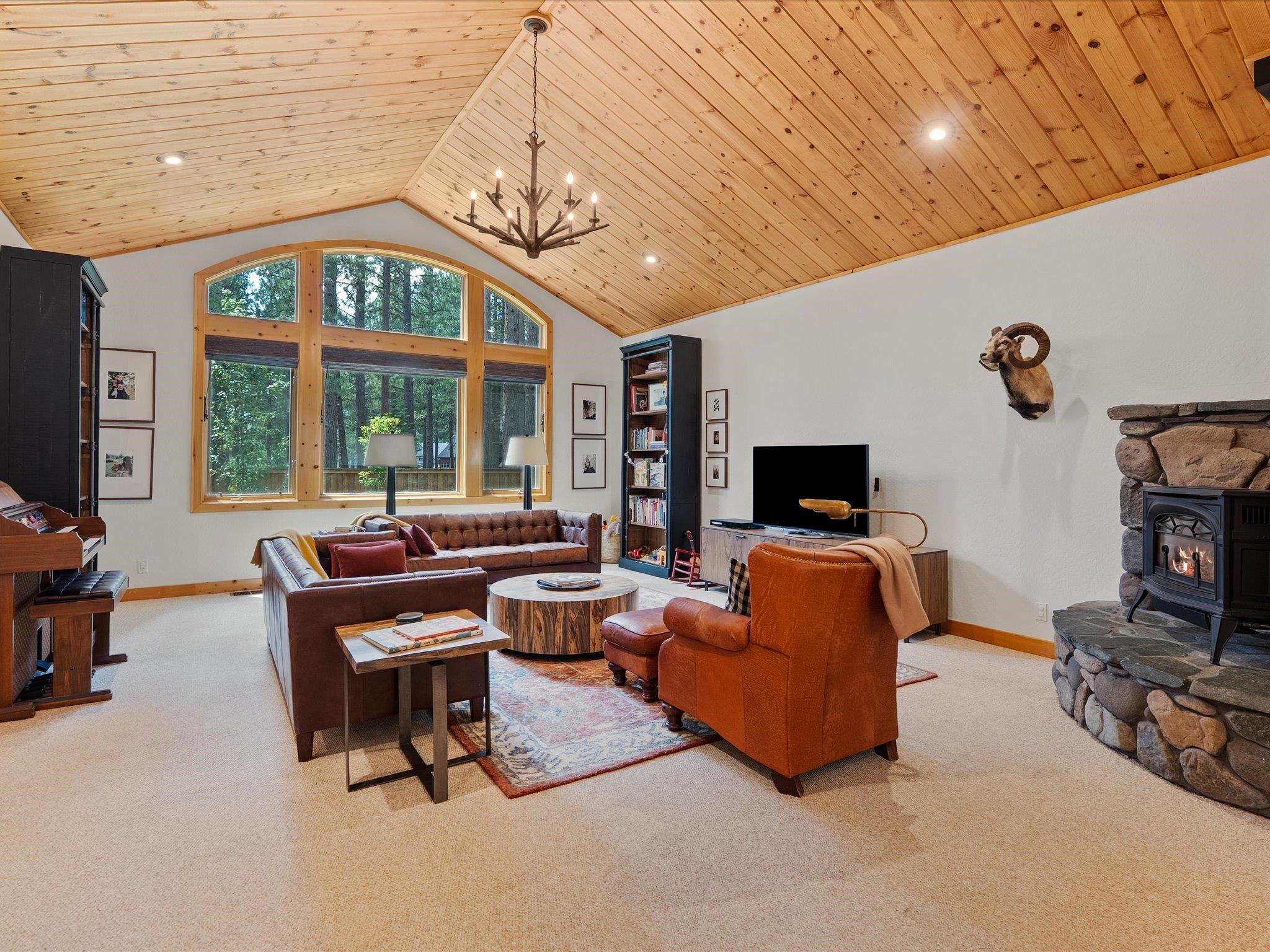 355 Quail View Circle Clio, CA 96106 - Photo 15 of 48 a living room with furniture a fireplace and a flat screen tv