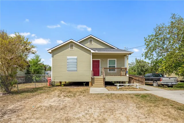 a front view of a house with a garden