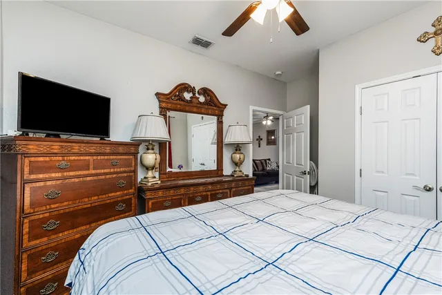 a bedroom with a bed and a flat screen tv