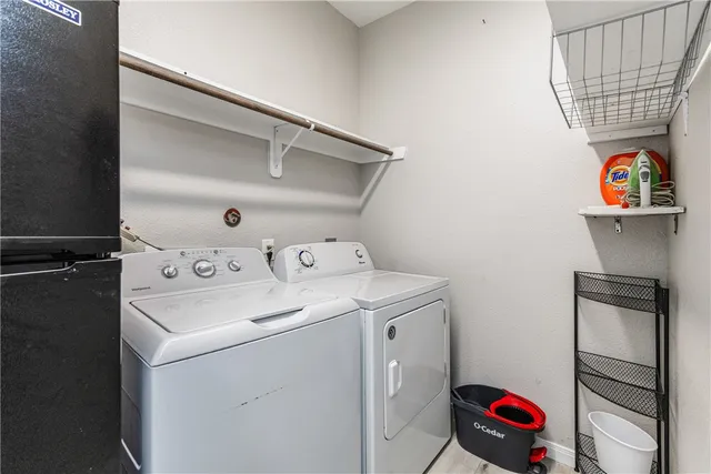 a kitchen with stainless steel appliances granite countertop a sink dishwasher a refrigerator and a stove