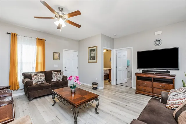 a living room with furniture and a wooden floor