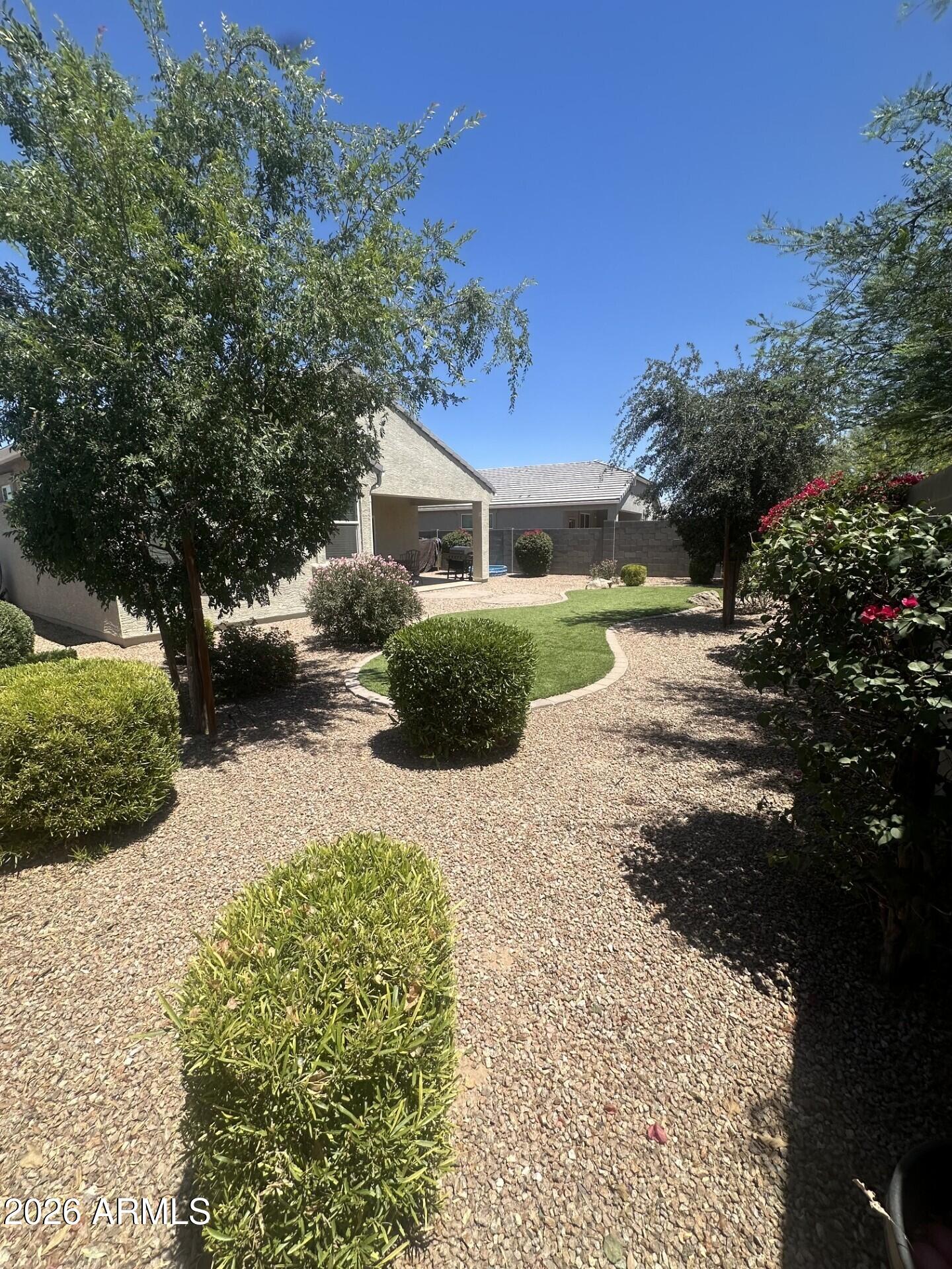7851 West Riverside Avenue Phoenix, AZ 85043 - Photo 21 of 40 a front view of a house with a yard and garage
