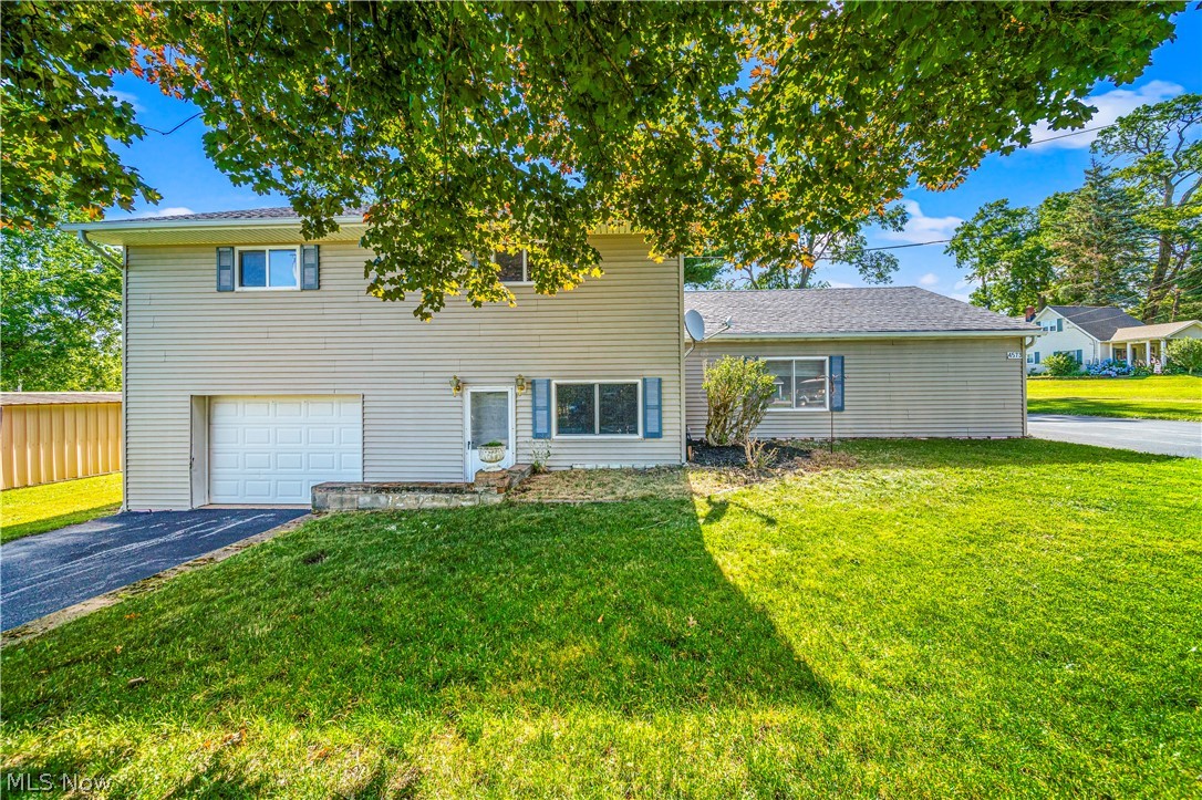 View of front with a garage, two driveways