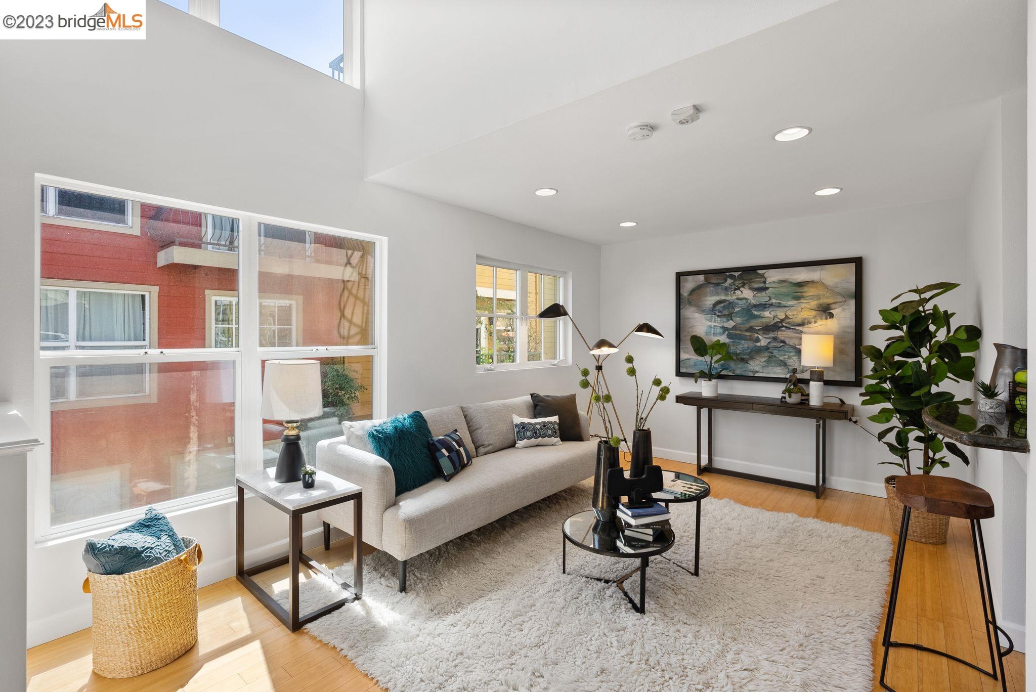 a living room with furniture a window and a flat screen tv