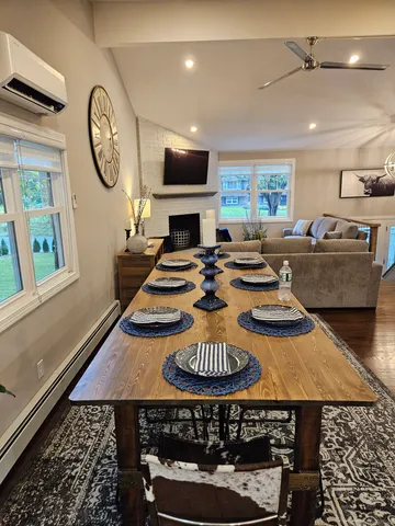 a living room with furniture a rug and a fireplace