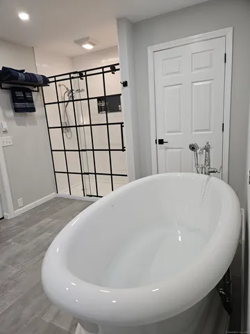 a large white tub sitting in a bathroom