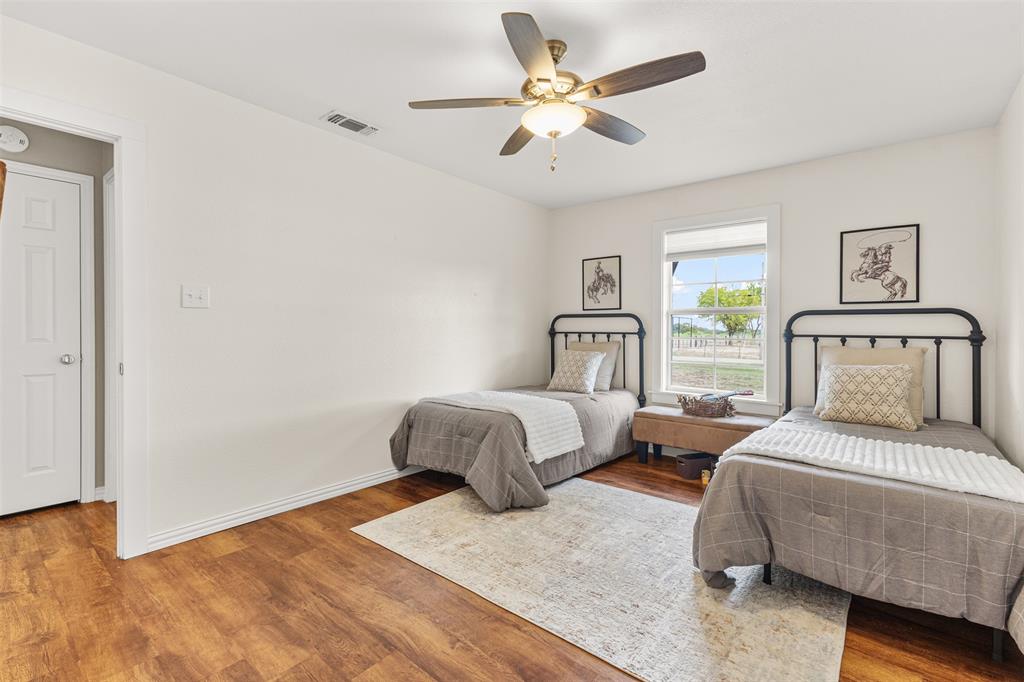 583 County Rd NW 1010 Road Northwest Mount Vernon, TX 75457 - Photo 14 of 40 a bedroom with a bed and a chandelier