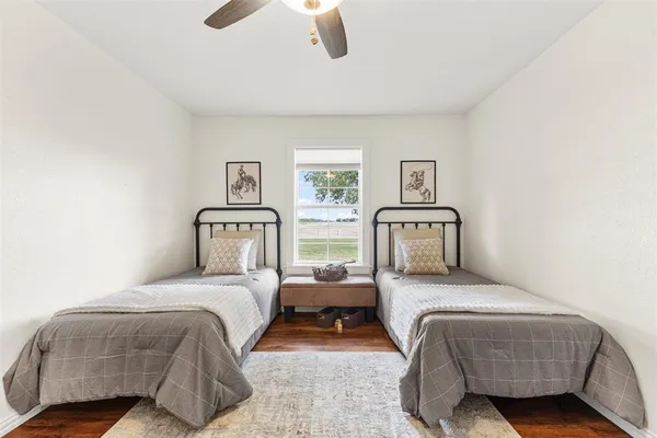a bedroom with two beds and painting on the wall