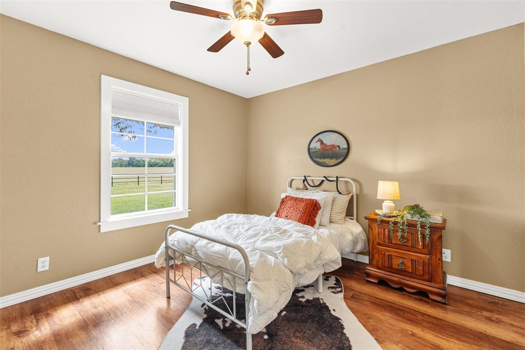 583 County Rd NW 1010 Road Northwest Mount Vernon, TX 75457 - Photo 17 of 40 a bedroom with a bed a dresser and next to a window