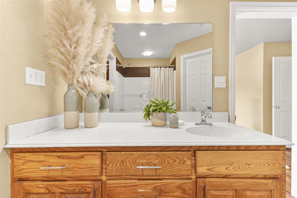 583 County Rd NW 1010 Road Northwest Mount Vernon, TX 75457 - Photo 21 of 40 a bathroom with a granite countertop sink and a mirror