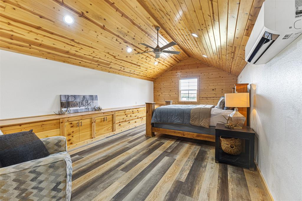 583 County Rd NW 1010 Road Northwest Mount Vernon, TX 75457 - Photo 27 of 40 a bedroom with furniture and a wooden floor