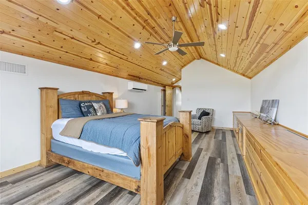 a bed sitting in a bedroom next to a larger window