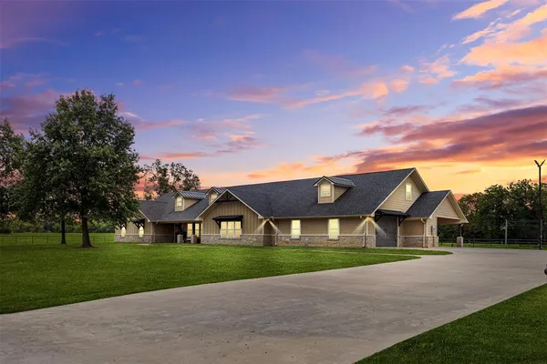 a front view of house with yard and green space