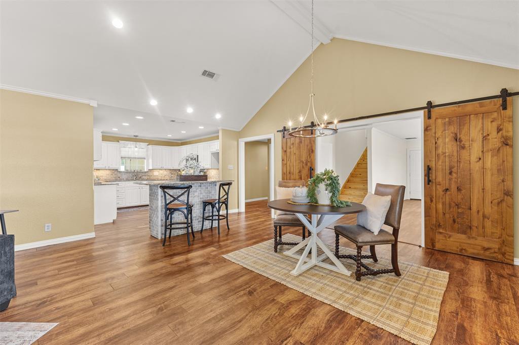 583 County Rd NW 1010 Road Northwest Mount Vernon, TX 75457 - Photo 7 of 40 a dining room with stainless steel appliances kitchen island granite countertop a dining table chairs and a refrigerator