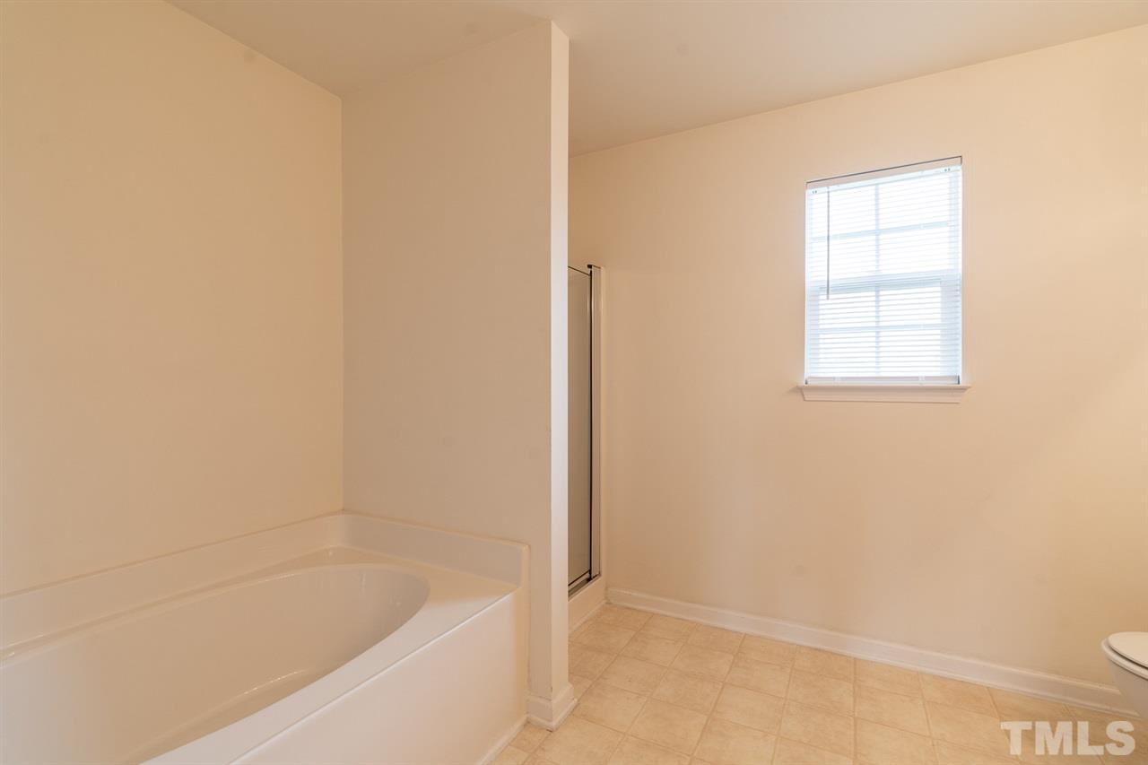 3820 Watkins Ridge Court Raleigh, NC 27616 - Photo 13 of 22 a bathroom with a bathtub