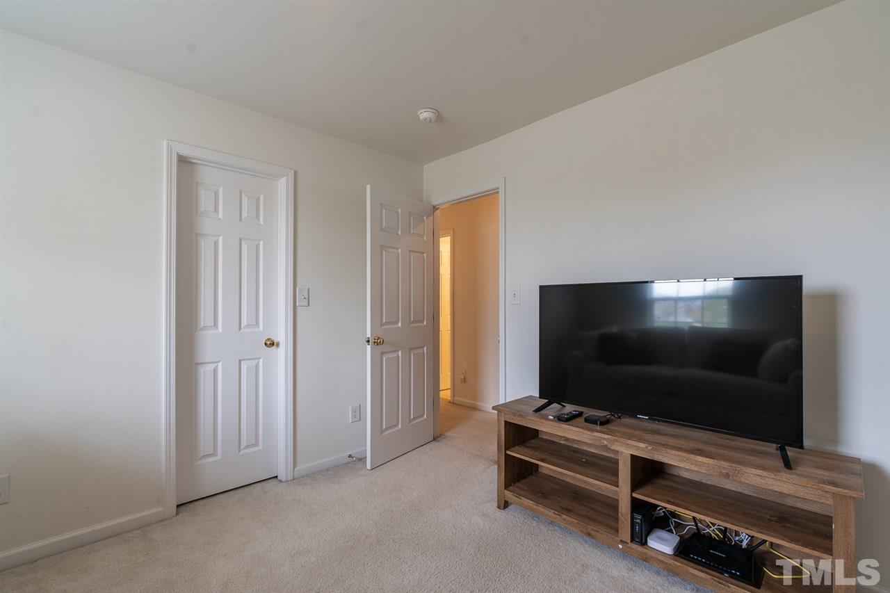 3820 Watkins Ridge Court Raleigh, NC 27616 - Photo 15 of 22 a living room with furniture and a flat screen tv