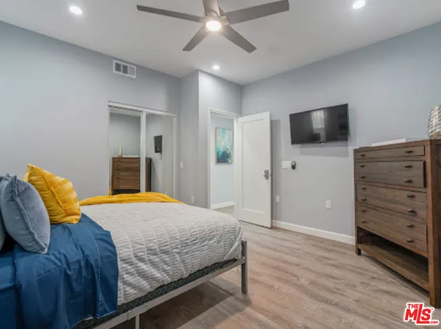 a spacious bedroom with a bed and furniture