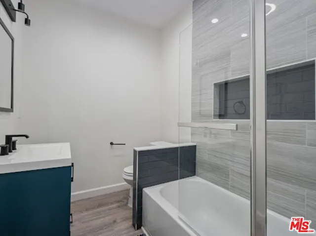 a bathroom with a sink vanity and mirror