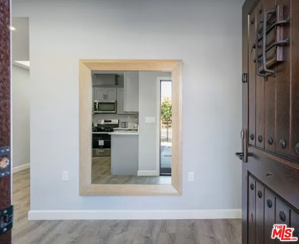 a kitchen with stainless steel appliances granite countertop a stove top oven a sink a dining table and chairs