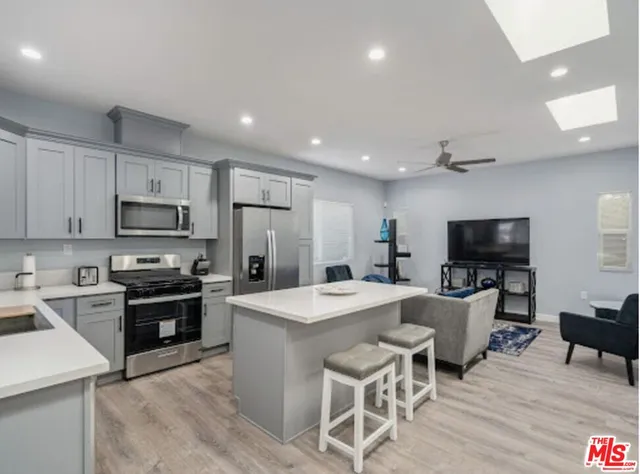 a kitchen with stainless steel appliances granite countertop a sink stove and cabinets