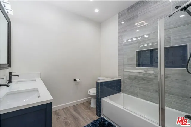 a bathroom with a sink vanity and mirror