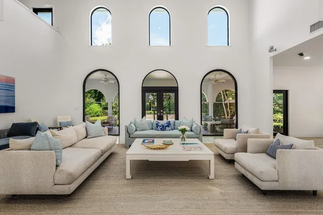 a living room with patio furniture and window