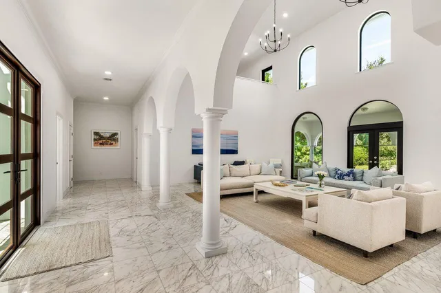 a large kitchen with stainless steel appliances kitchen island granite countertop a large dining table and chairs with wooden floor