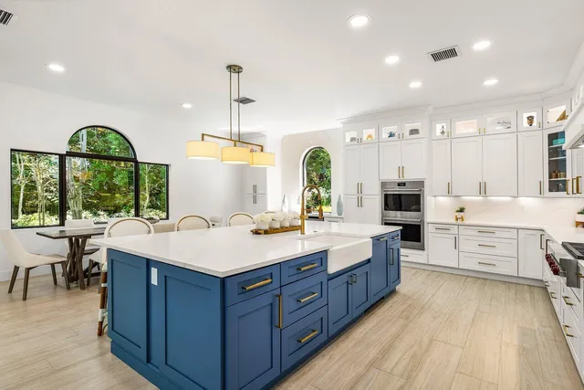 a large kitchen with stainless steel appliances granite countertop a stove and a sink