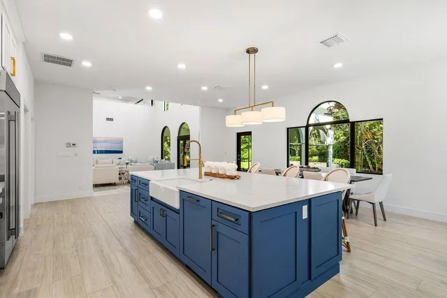 a kitchen with stainless steel appliances a stove a sink and a refrigerator