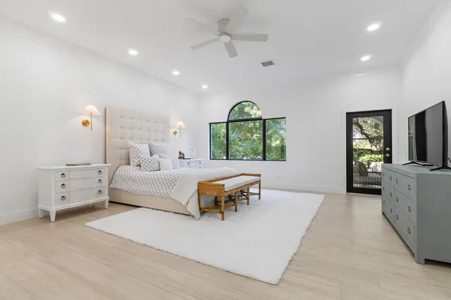 a bathroom with a granite countertop toilet sink and mirror