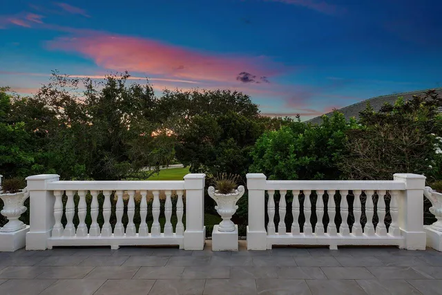 a view of a patio with table and chairs potted plants with large tree