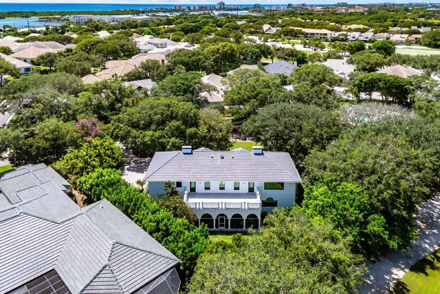 an aerial view of residential houses with outdoor space and swimming pool
