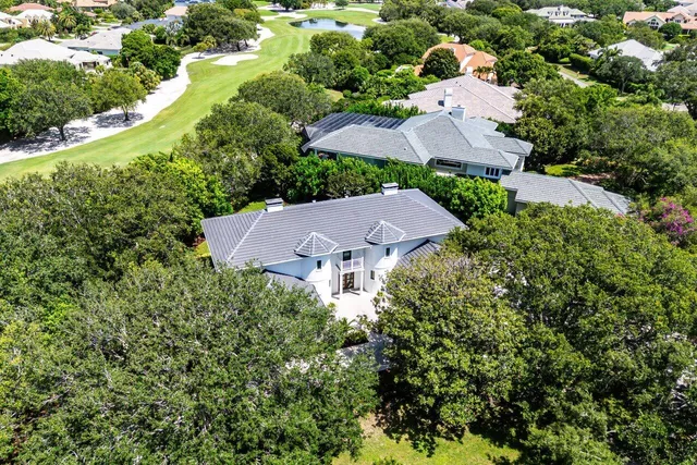 an aerial view of house with yard and outdoor seating
