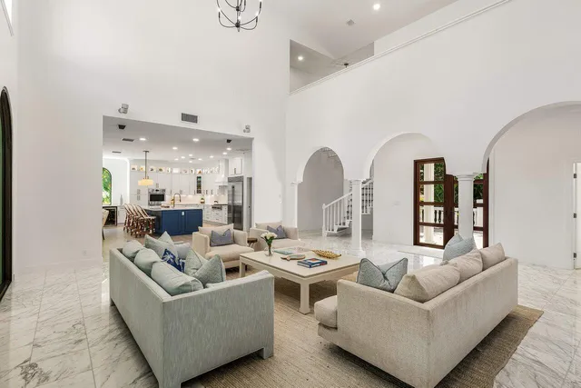 a living room with furniture and a view of kitchen