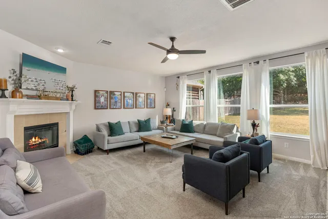 a living room with furniture and a fireplace