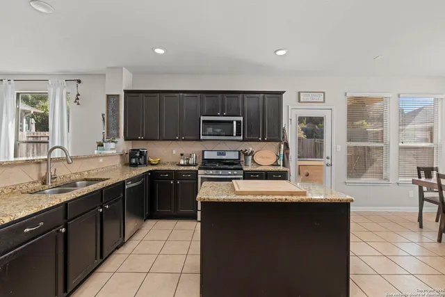 a kitchen with a sink stove and microwave