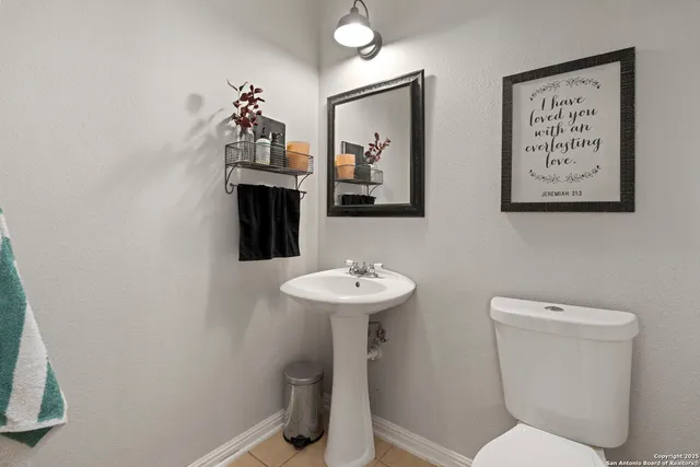 a bathroom with a toilet a sink and a mirror