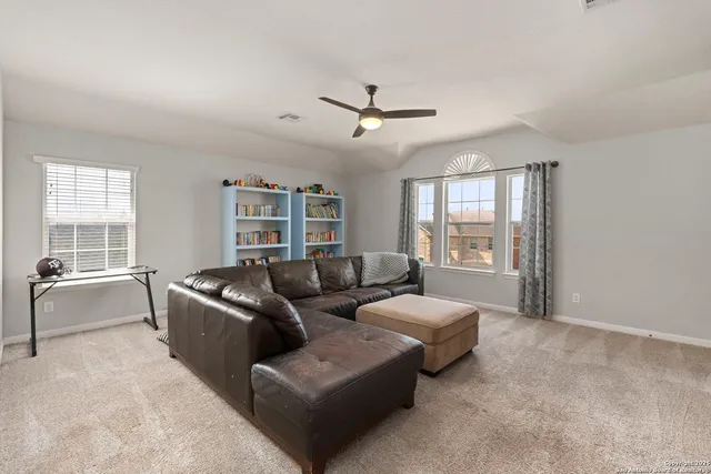 a living room with furniture and windows