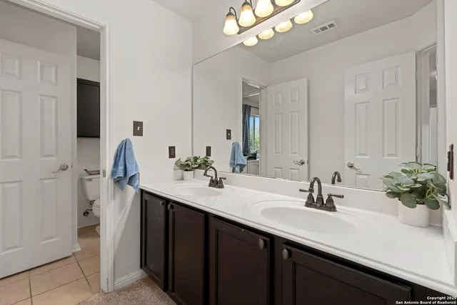 a bathroom with a sink double vanity and a mirror