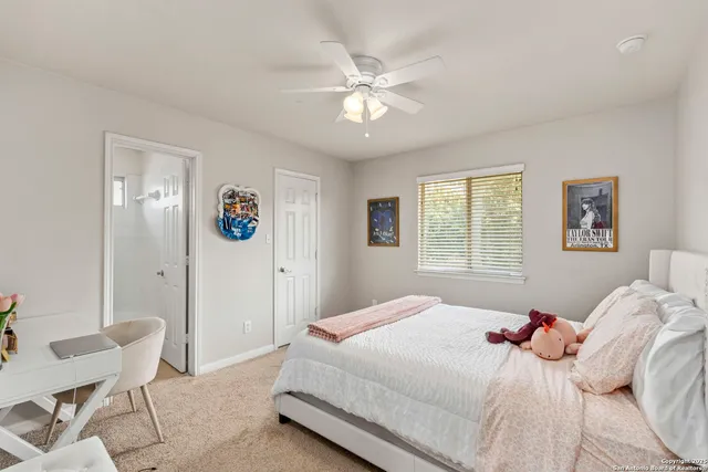 a bedroom with a large bed and a window
