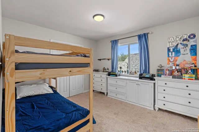 a bedroom with a bed and a dresser
