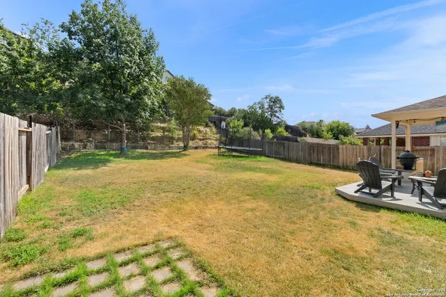 a view of a swimming pool with a yard