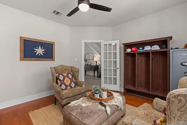 a living room with furniture and a wooden floor