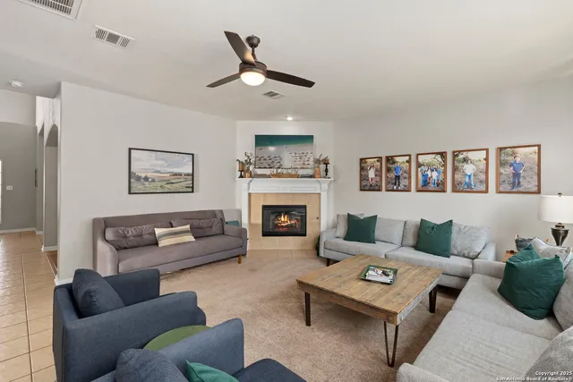 a living room with furniture and a fireplace