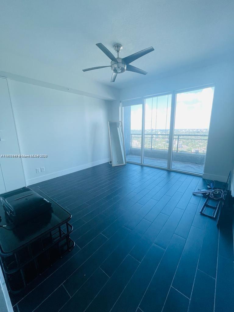 60 Southwest 13th Street, Unit 3606 Miami, FL 33130 - Photo 12 of 22 wooden floor in an empty room with a window