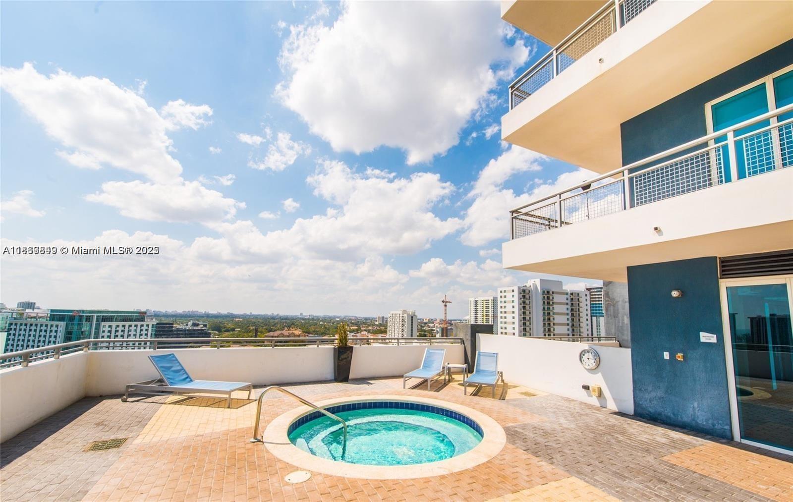 60 Southwest 13th Street, Unit 3606 Miami, FL 33130 - Photo 19 of 22 a swimming pool with outdoor seating and barbeque area