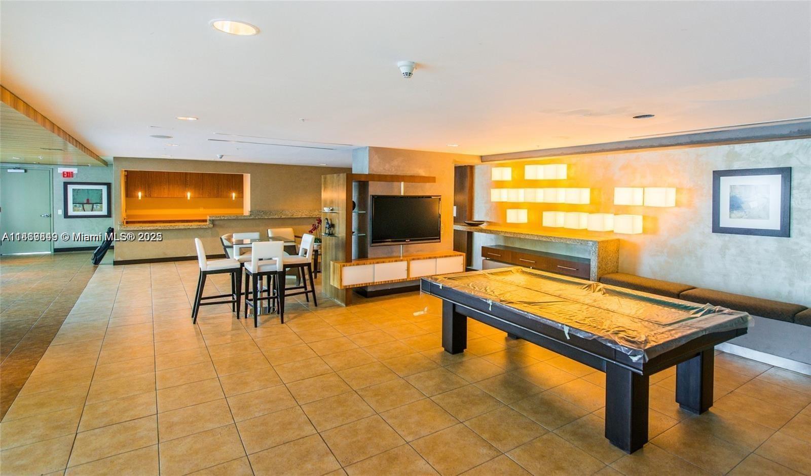 60 Southwest 13th Street, Unit 3606 Miami, FL 33130 - Photo 20 of 22 a living room with furniture pool table and flat screen tv