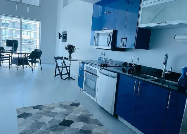 a kitchen with sink cabinets and window