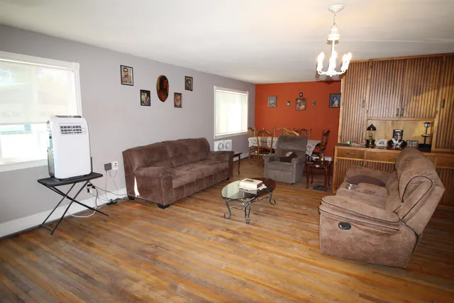 a living room with furniture and a chandelier